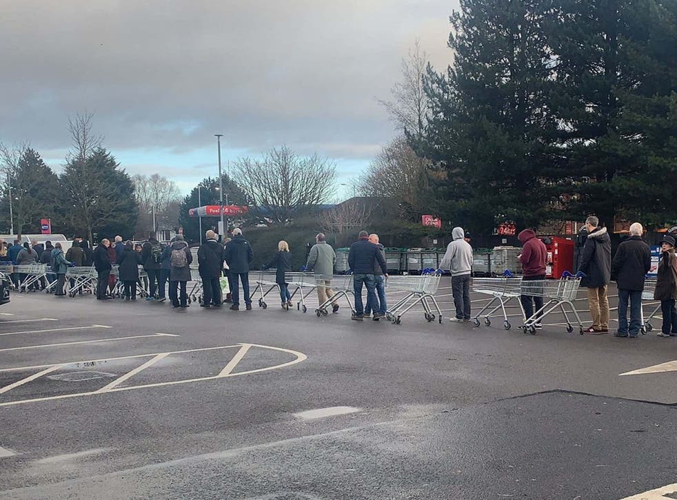 People queue for bottled water at the Tesco on Vimy Road in Leighton Buzzard after thousands were left without water