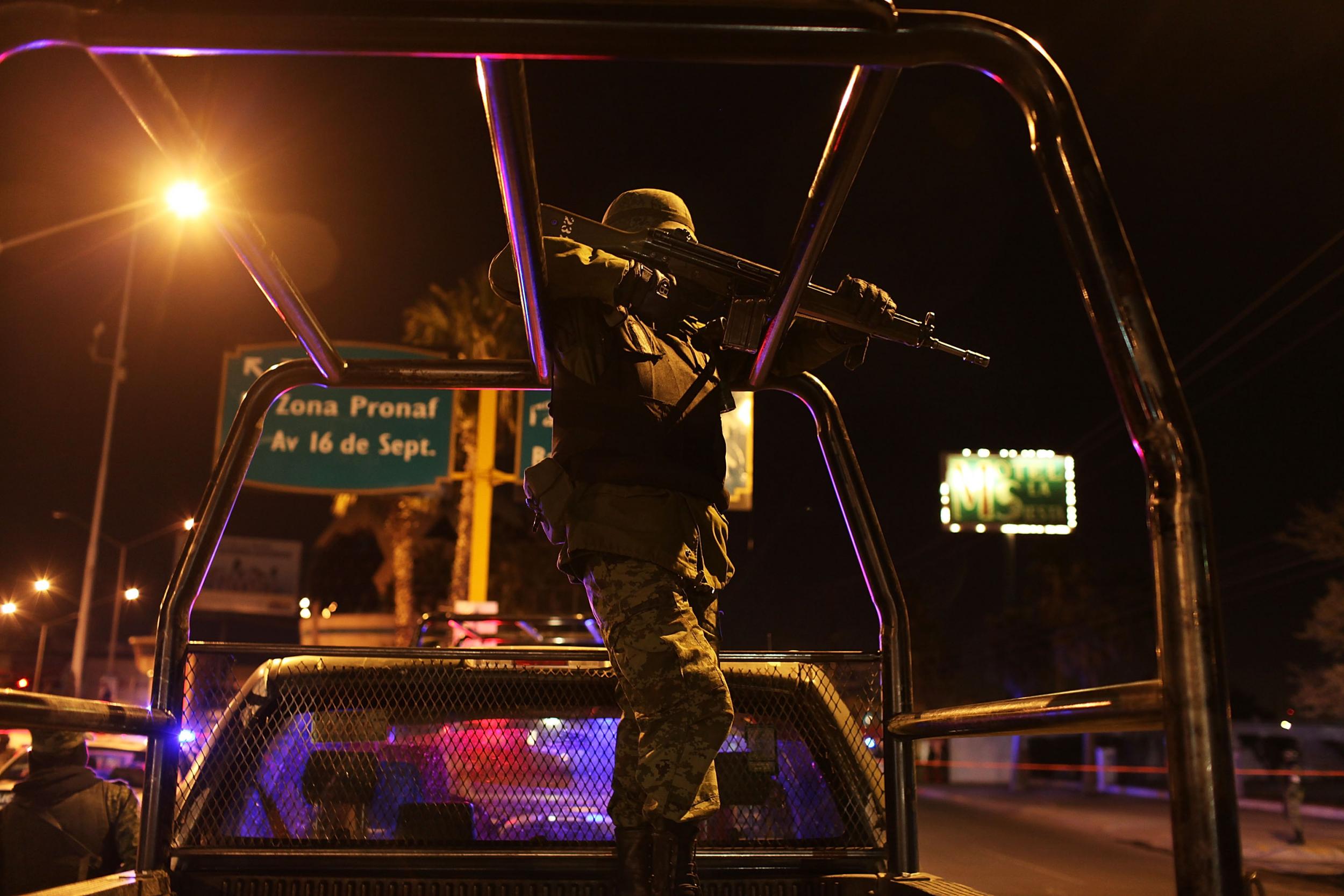 Military police gather at an early morning murder in Juarez, Mexico