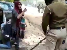 Women in hijabs stand up to riot police in India