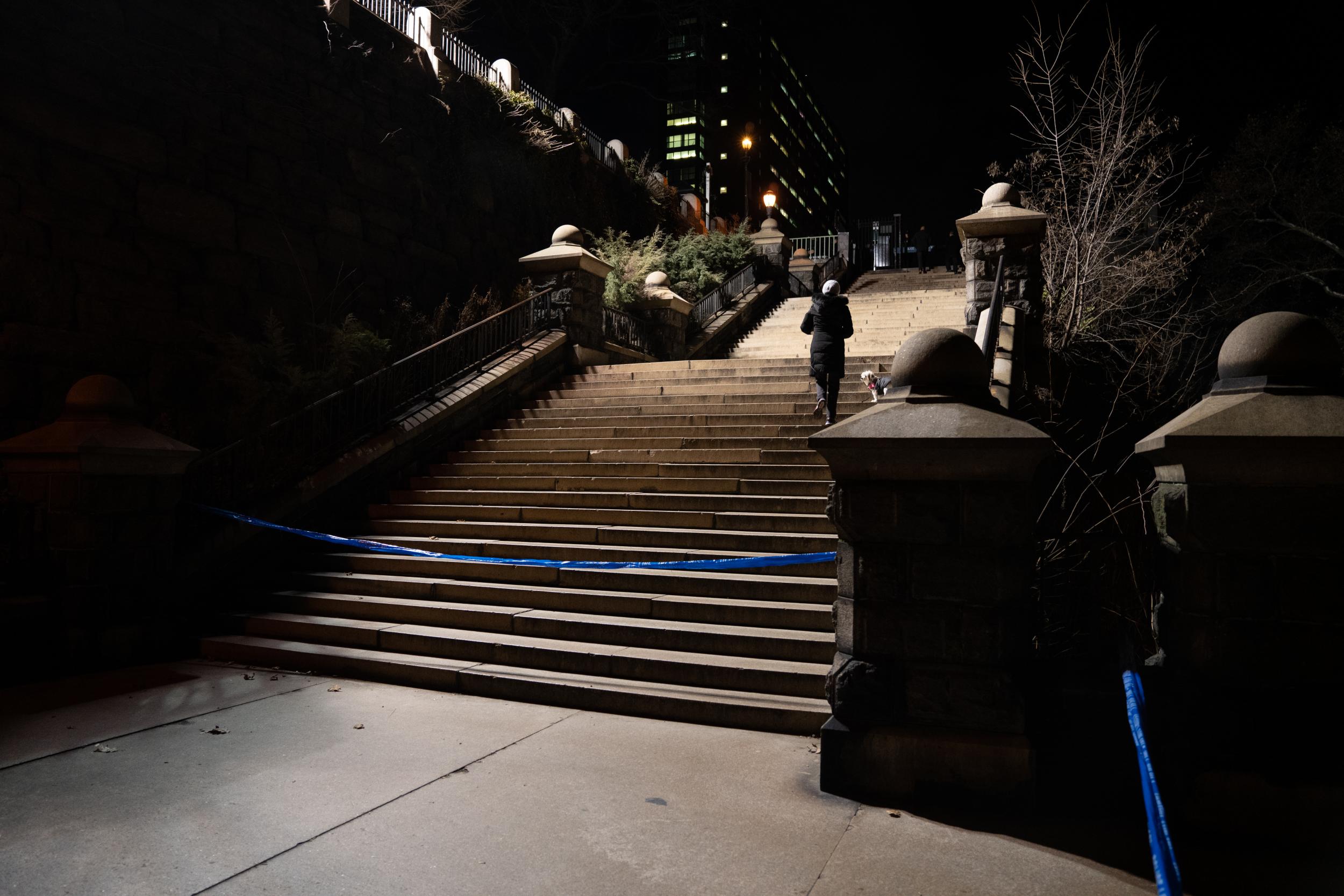 A woman walks near a police blocked area after a candlelight vigil held to remember murdered Tessa Majors on 15 December, 2019 in New York City.