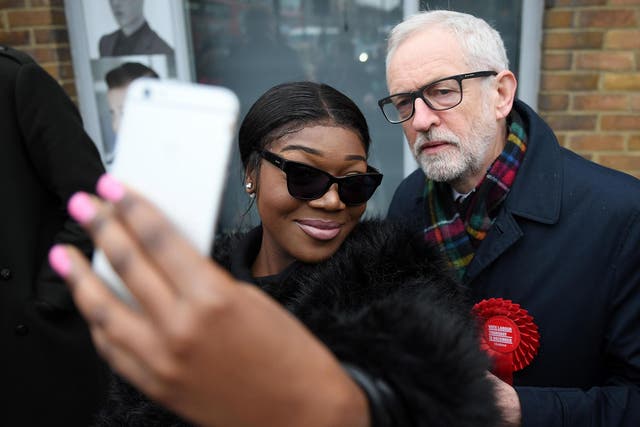 Jeremy Corbyn poses for a selfie with a voter in north London on election day
