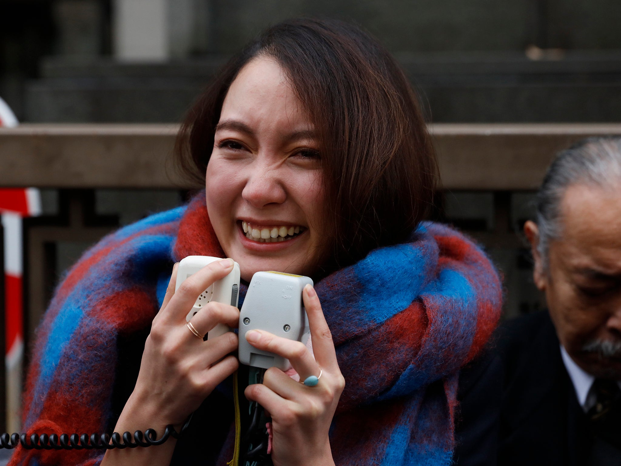 Ito talks to her supporters outside a courthouse