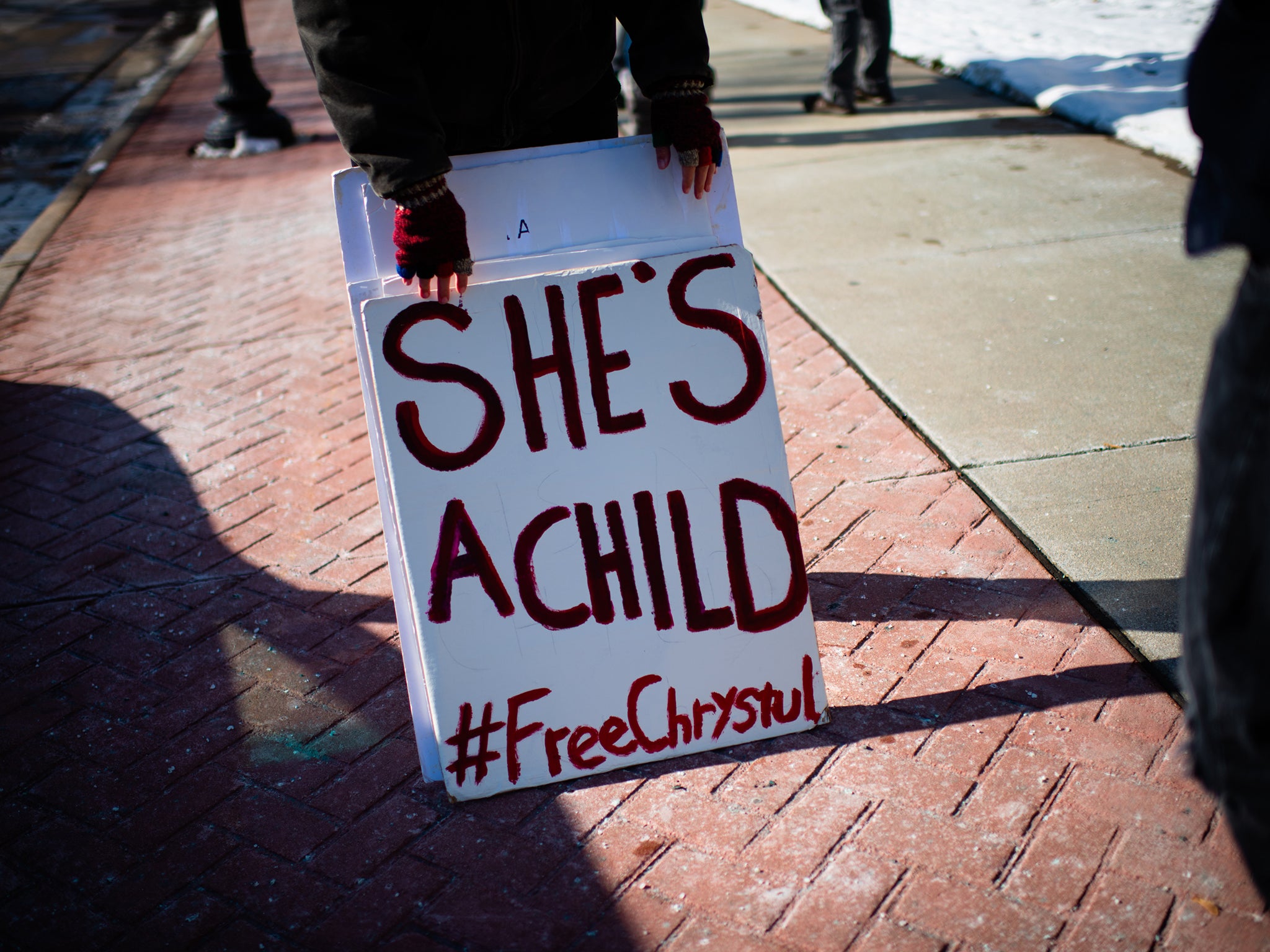 An activist stands outside the Kenosha County Courthouse