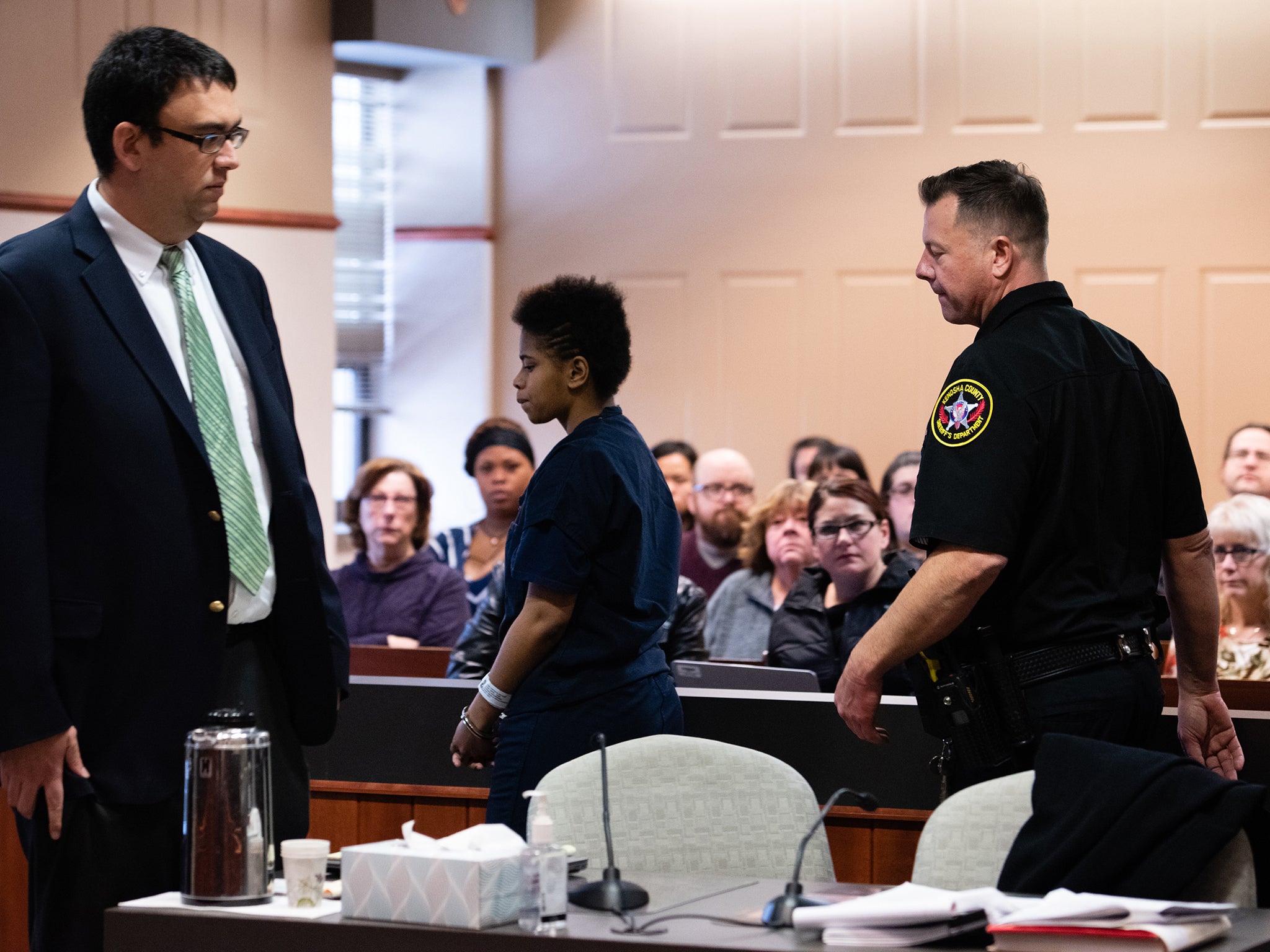 Kizer's mother and members of Volar's family watch her walk through the courtroom