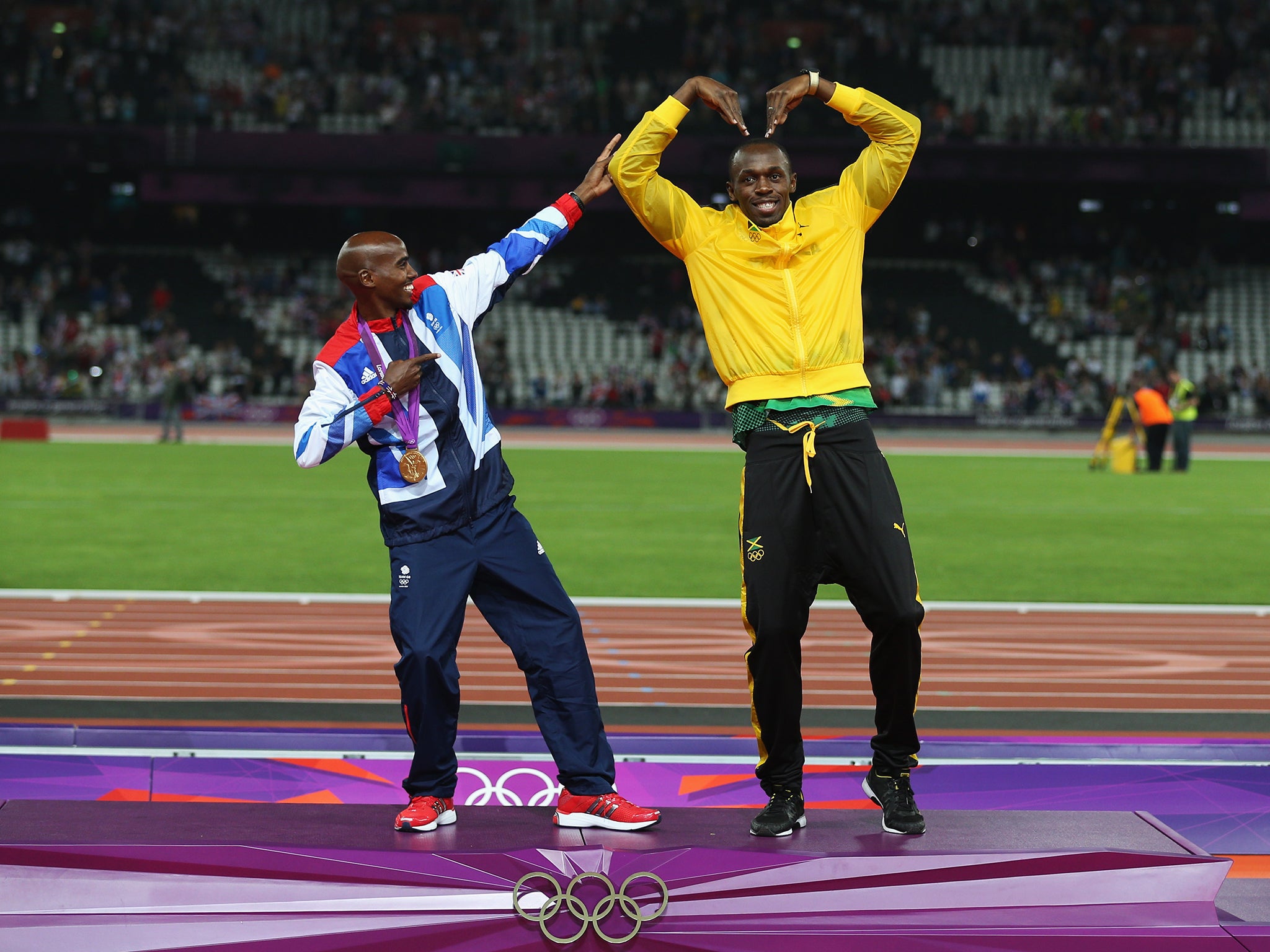 Mo Farah and Usain Bolt trade gestures at the London games