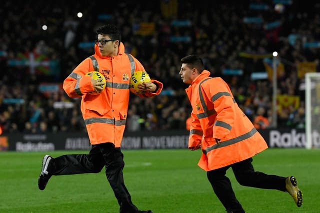 Protesters forced the Clasico to be temporarily halted by throwing balls onto the pitch