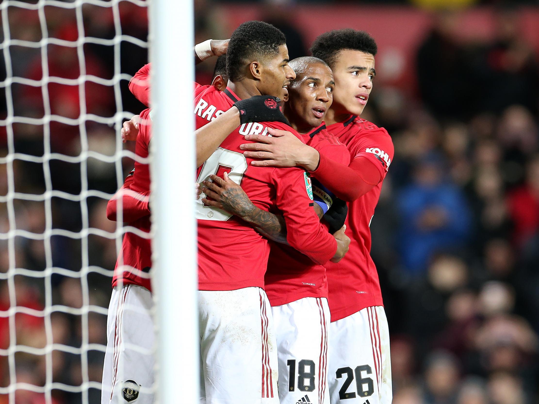 Manchester United celebrate their third goal against Colchester