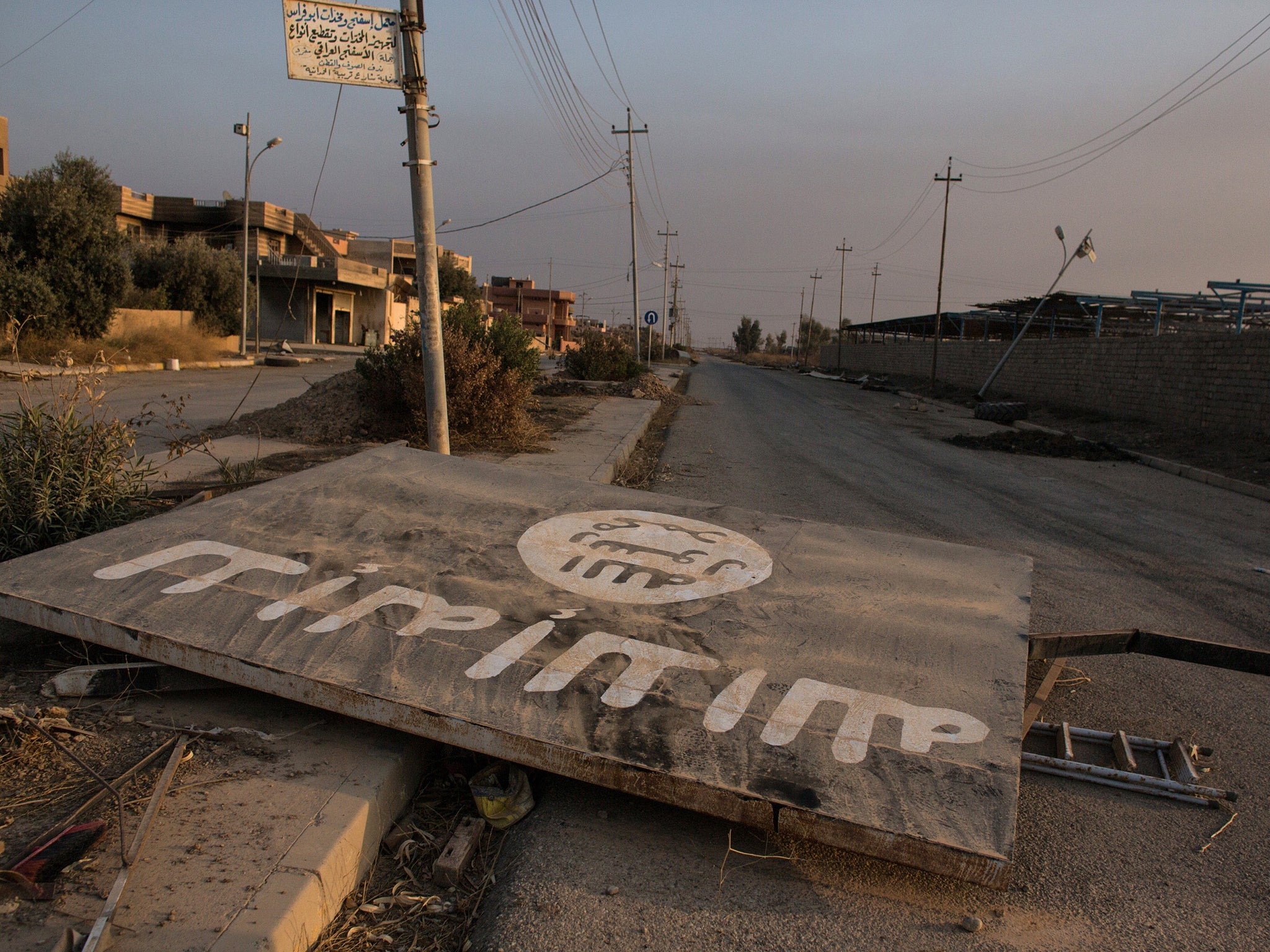 After the fall: an Isis billboard lies destroyed in the middle of the road