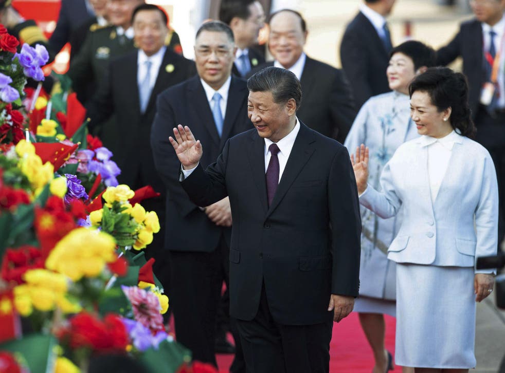 Chinese president Xi Jinping and his wife Peng Liyuan arrive at Macau airport