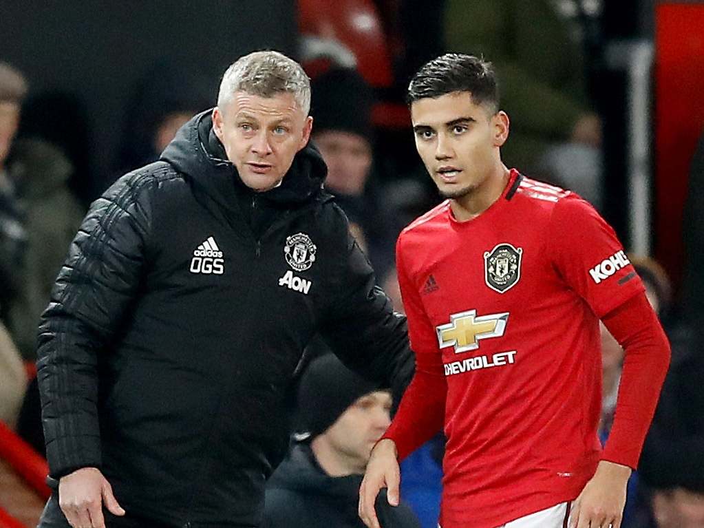 Manchester United manager Ole Gunnar Solskjaer speaks with Andreas Pereira