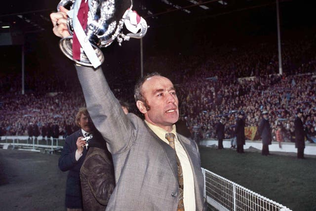 Saunders holds aloft the League Cup at Wembley after Villa’s win over Norwich in the 1975 final