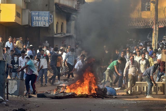 Demonstrators throw stones towards police during a protest against a new citizenship law, in Mangaluru (Mangalore), India, 19 December, 2019.