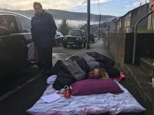 Donna Gilby waiting for an ambulance on the pavement outside her home in Cwmaman