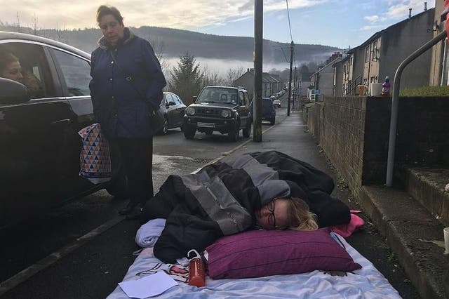 Donna Gilby waiting for an ambulance on the pavement outside her home in Cwmaman