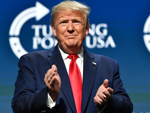 US President Donald Trump claps during the Turning Point USA Student Action Summit