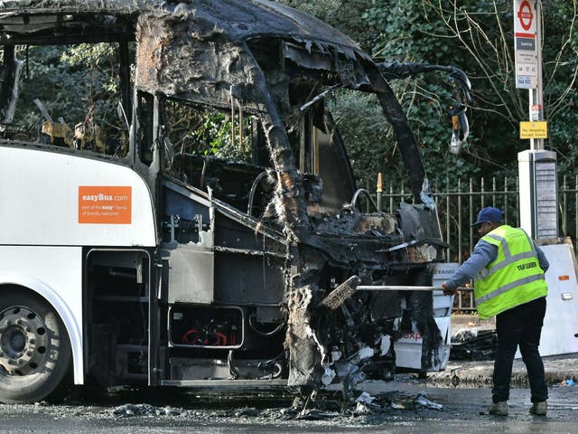 The burnt remains of a coach in Queenstown Road, near Chelsea Bridge