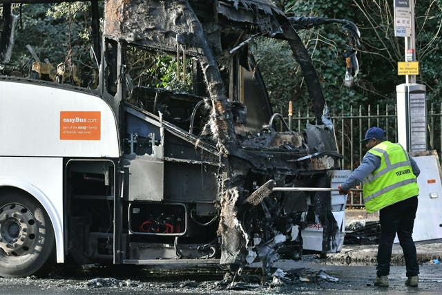 The burnt remains of a coach in Queenstown Road, near Chelsea Bridge
