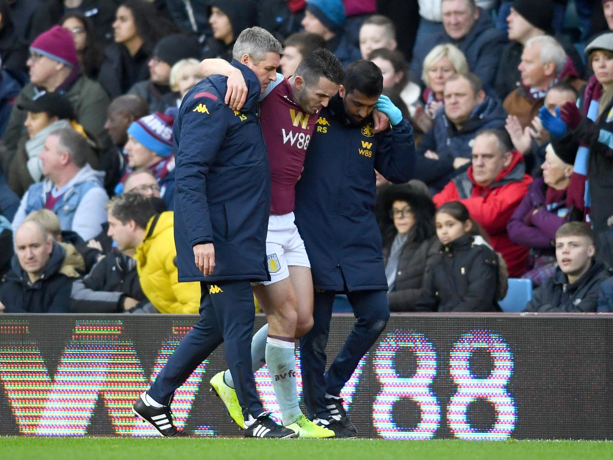 John McGinn is helped off the pitch after picking up an injury in the match between Villa and Southampton