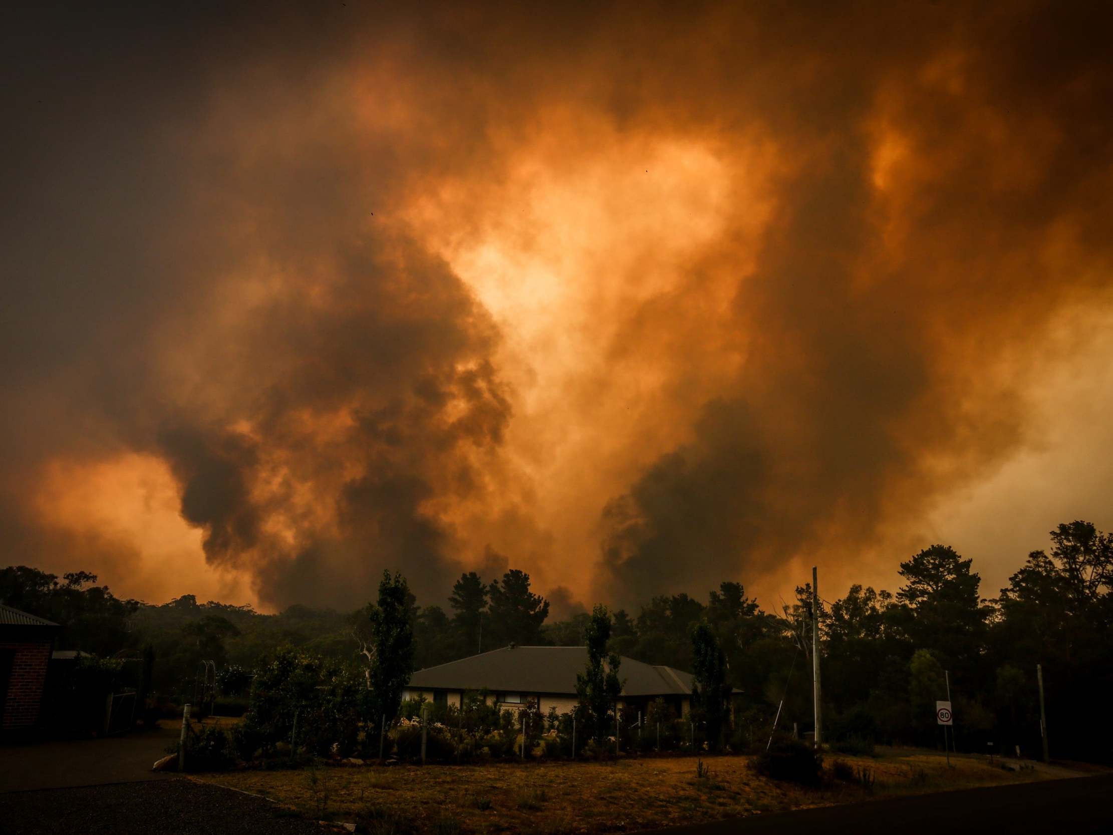 Two blazes approach a home in New South Wales on Saturday