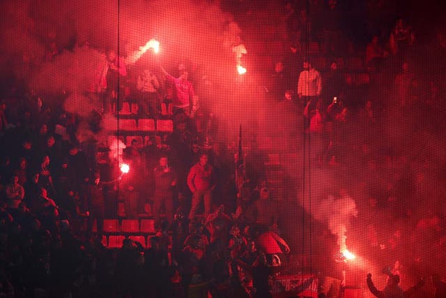 Flairs are lit during Olympiacos' Champions League tie against Crvena Zvezda