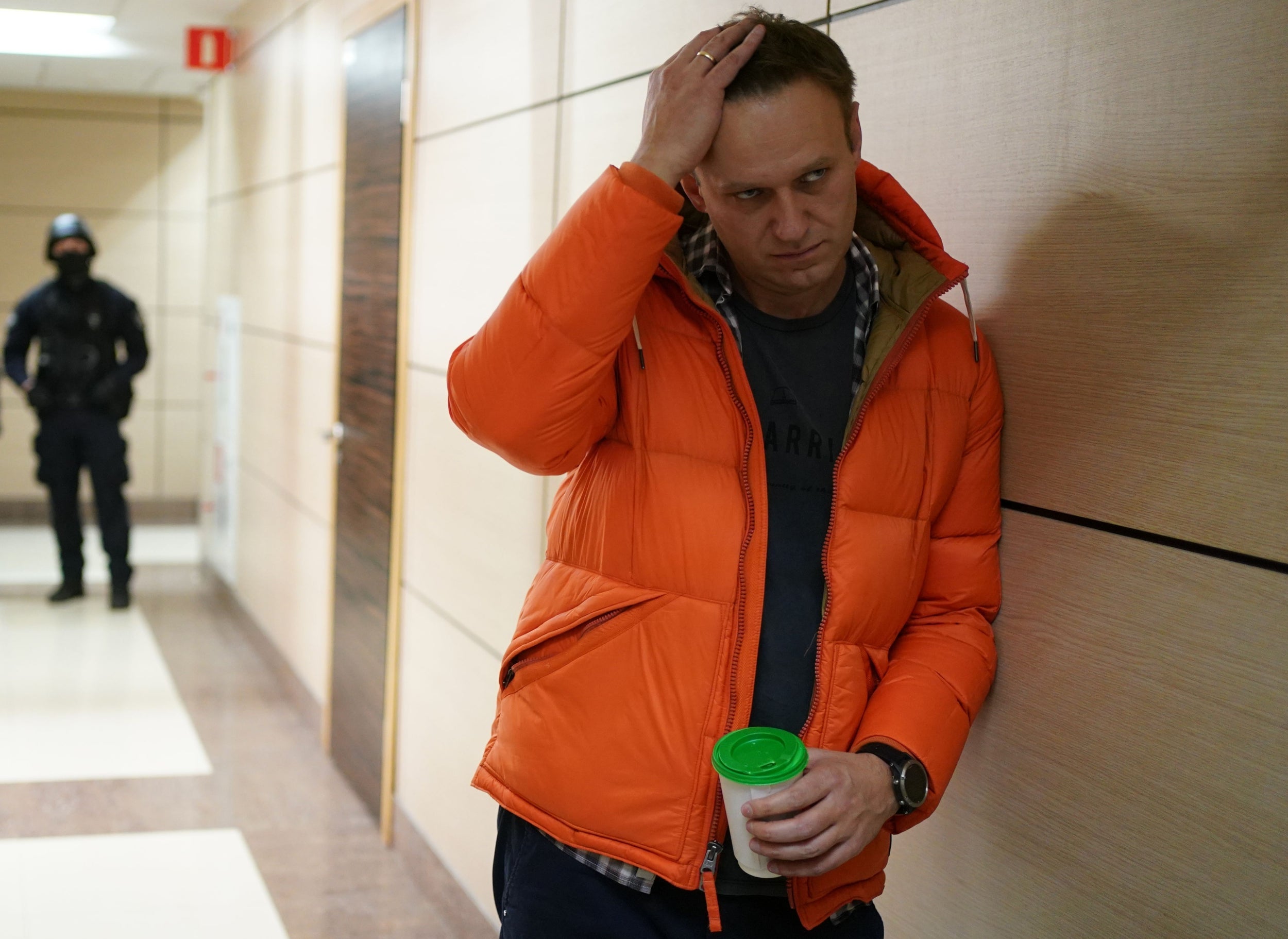 Russian opposition leader Alexei Navalny pictured last year in his offices, accompanied by law enforcement agents