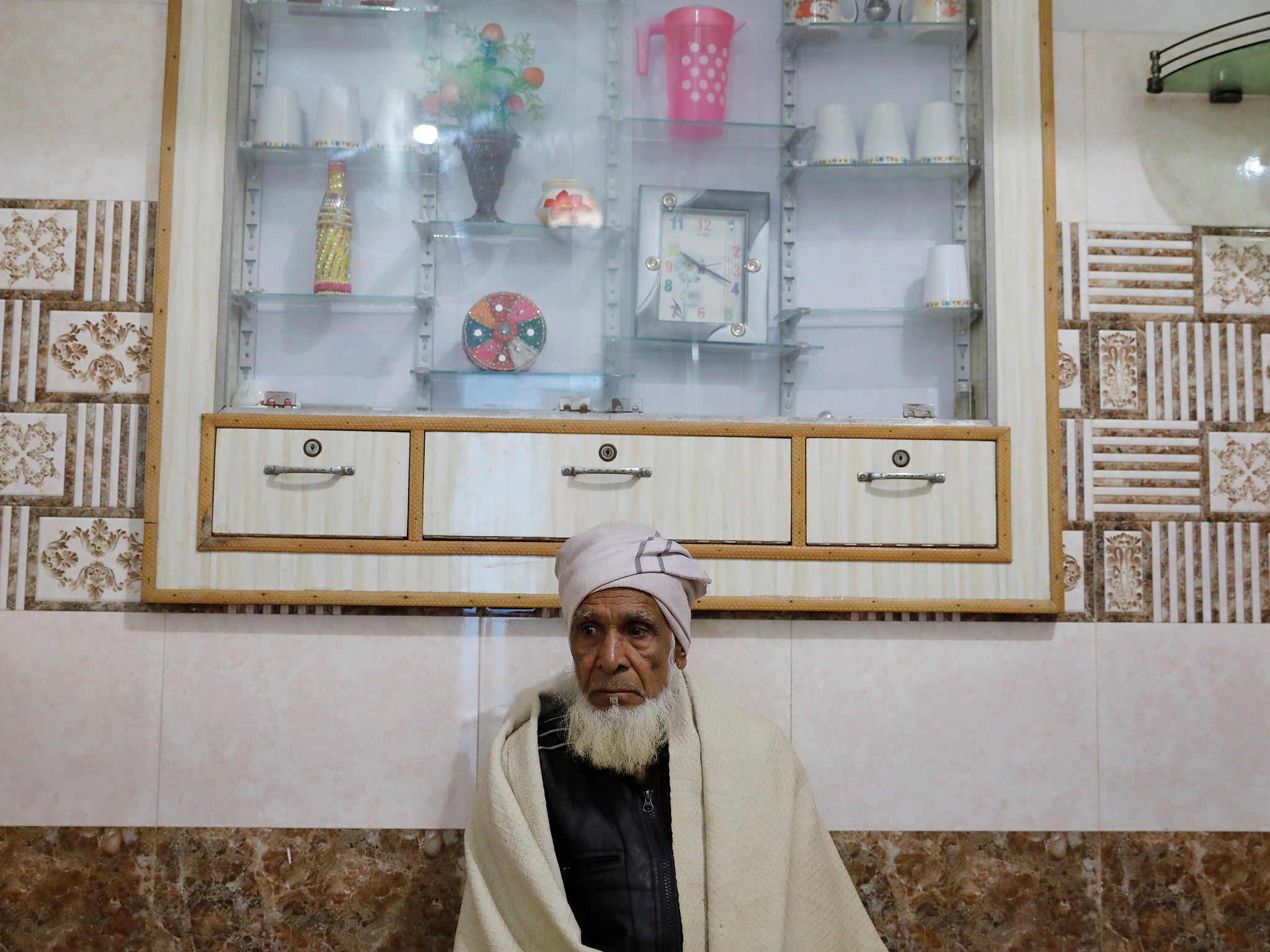 Munshi Ahmed, father of Zaheer Ahmed, sits inside a house in Meerut