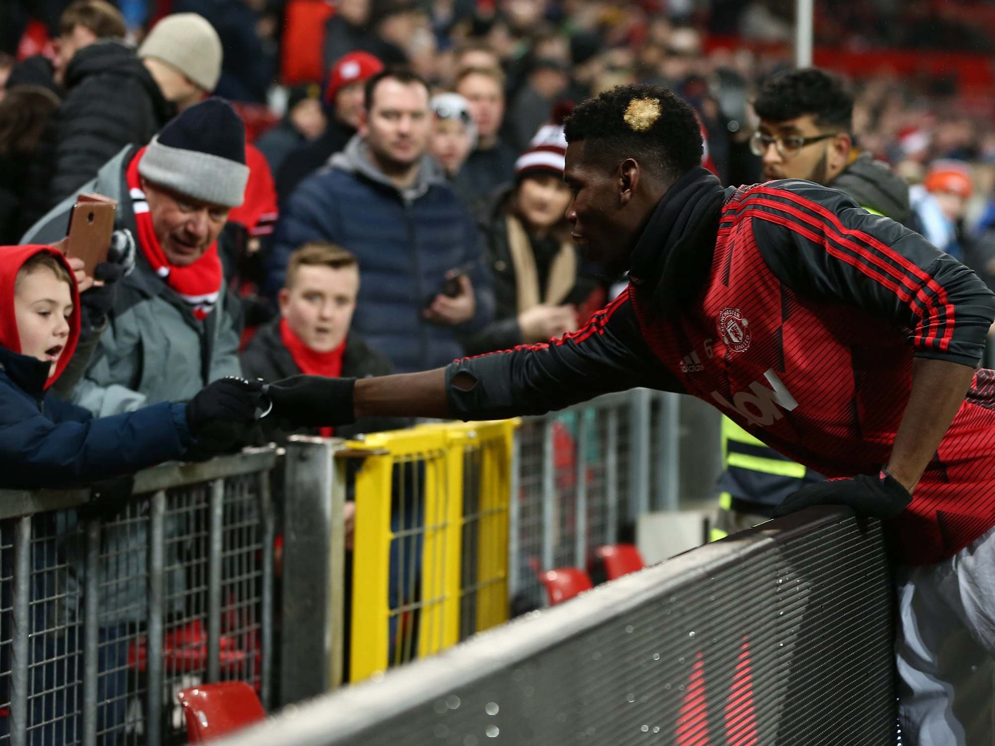 Paul Pogba gives his wristband to a young fan at Old Trafford