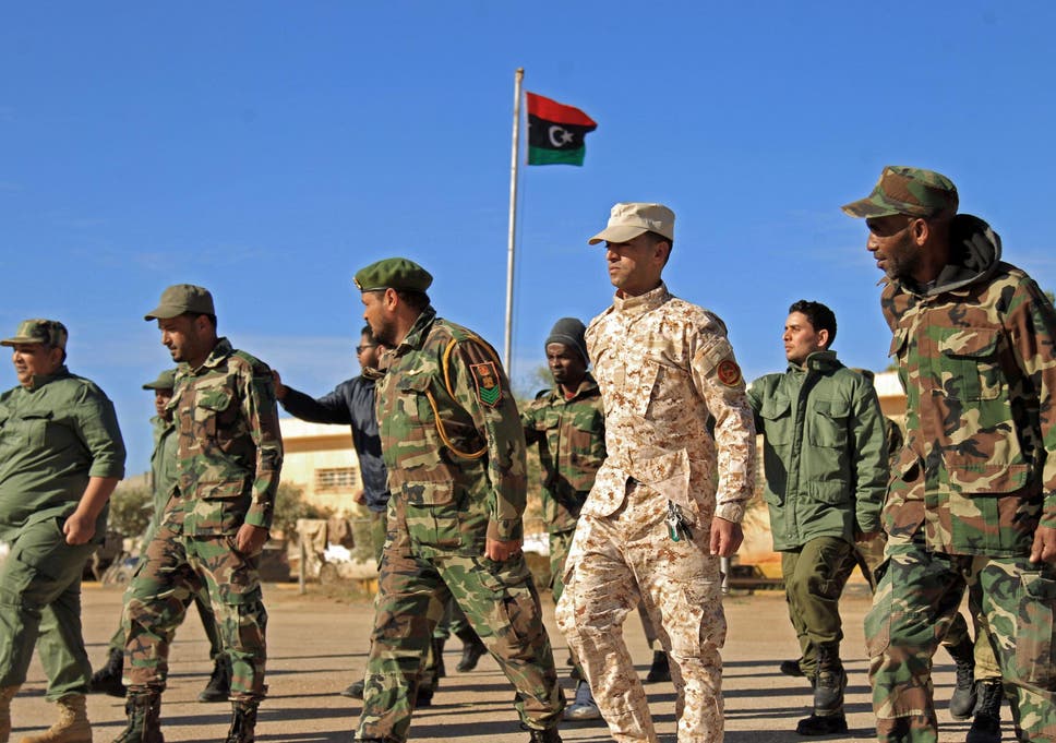 Fighters of a military battalion loyal to Libyan General Khalifa Haftar march during the morning assembly in the eastern city of Benghazi on December 18, 2019
