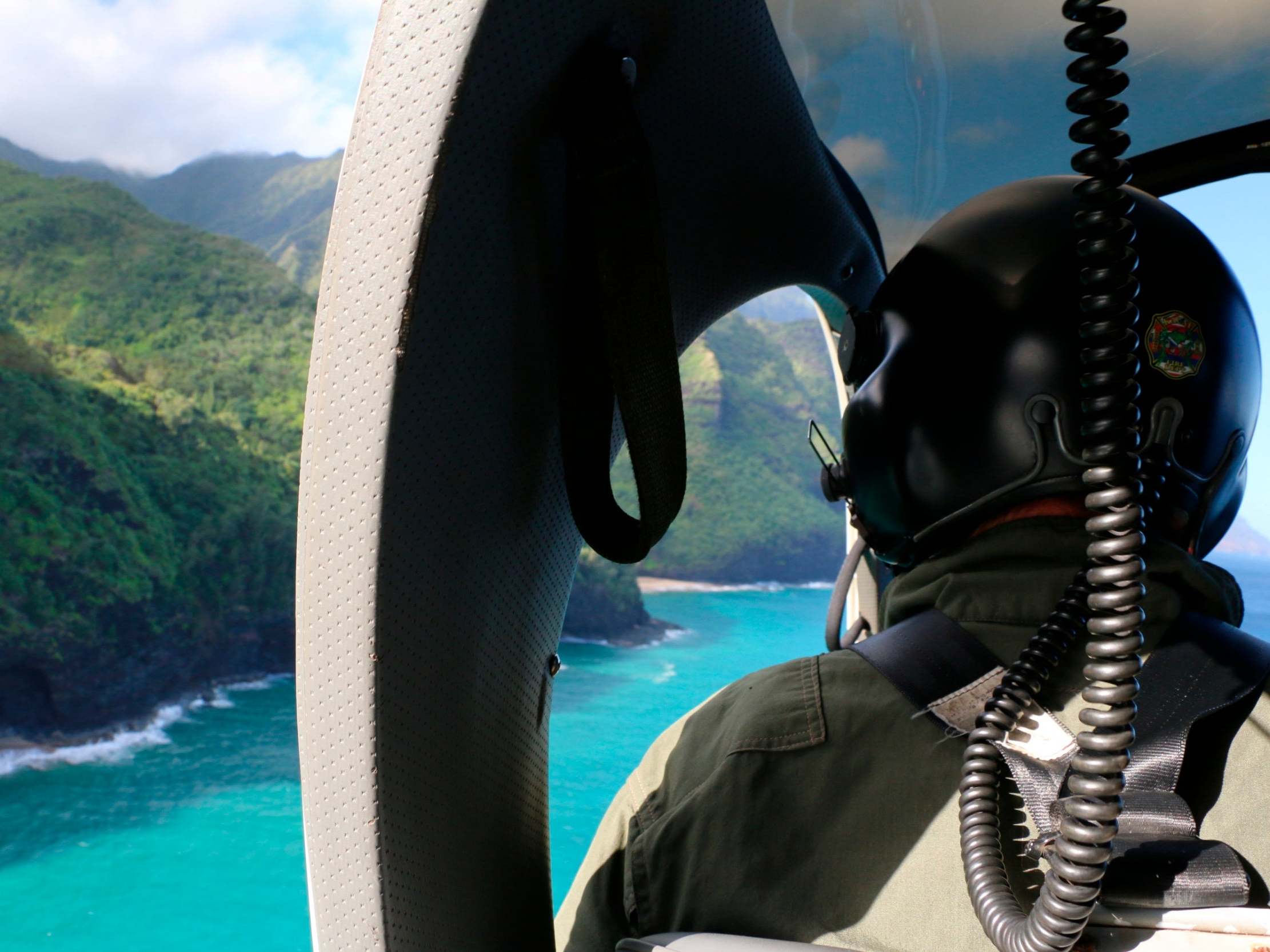 A Coast Guard search and rescue team look over Napali Coast State Wilderness Park for the previously missing helicopter