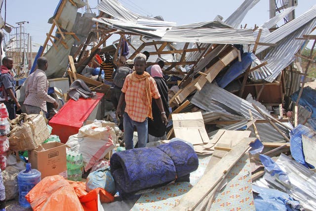 Locals salvage goods after shops were destroyed in a car bomb in Mogadishu on 28 December