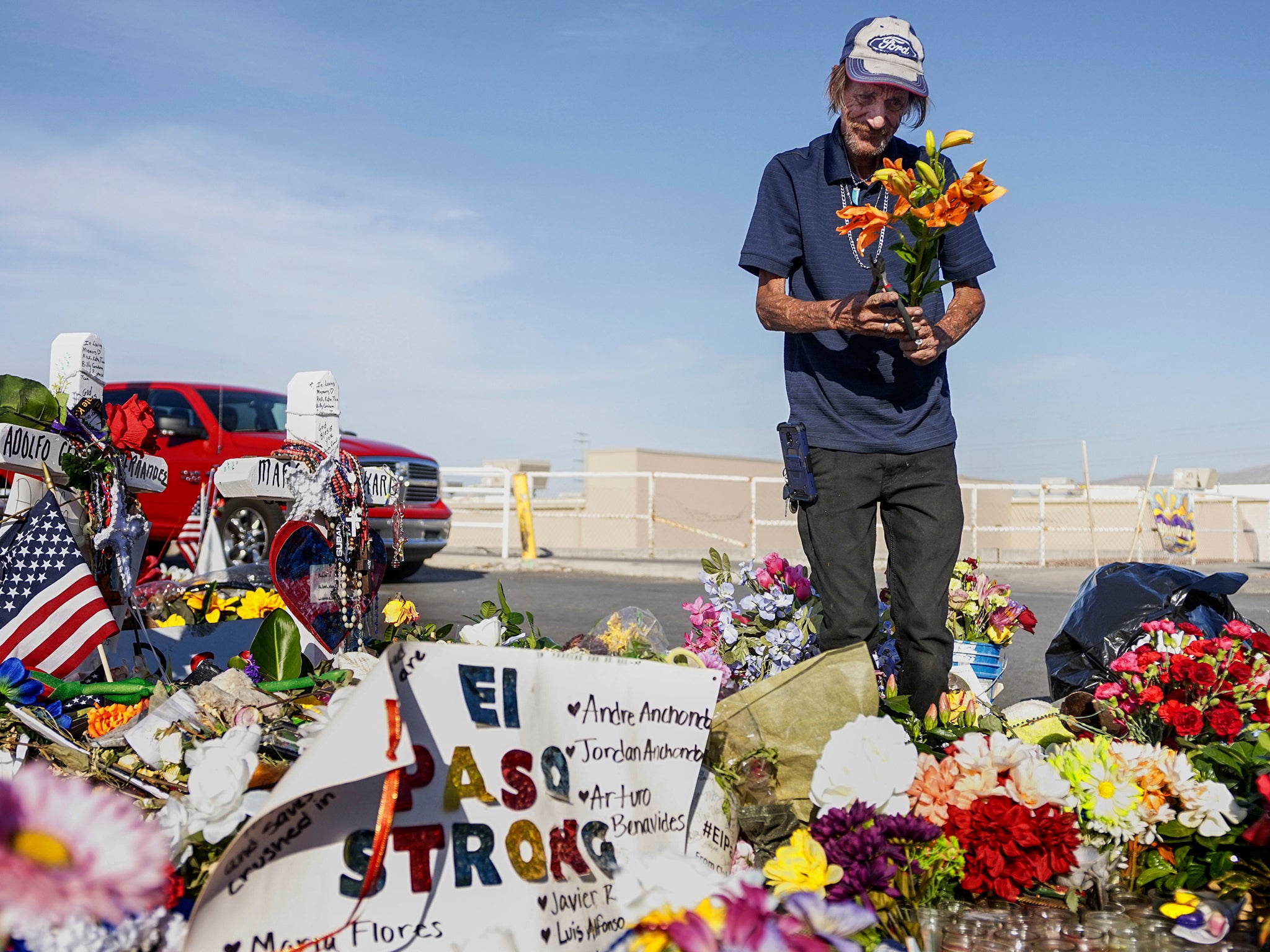 Antonio Basco, who's wife Margie Reckard was one of the El Paso victims, lays flowers