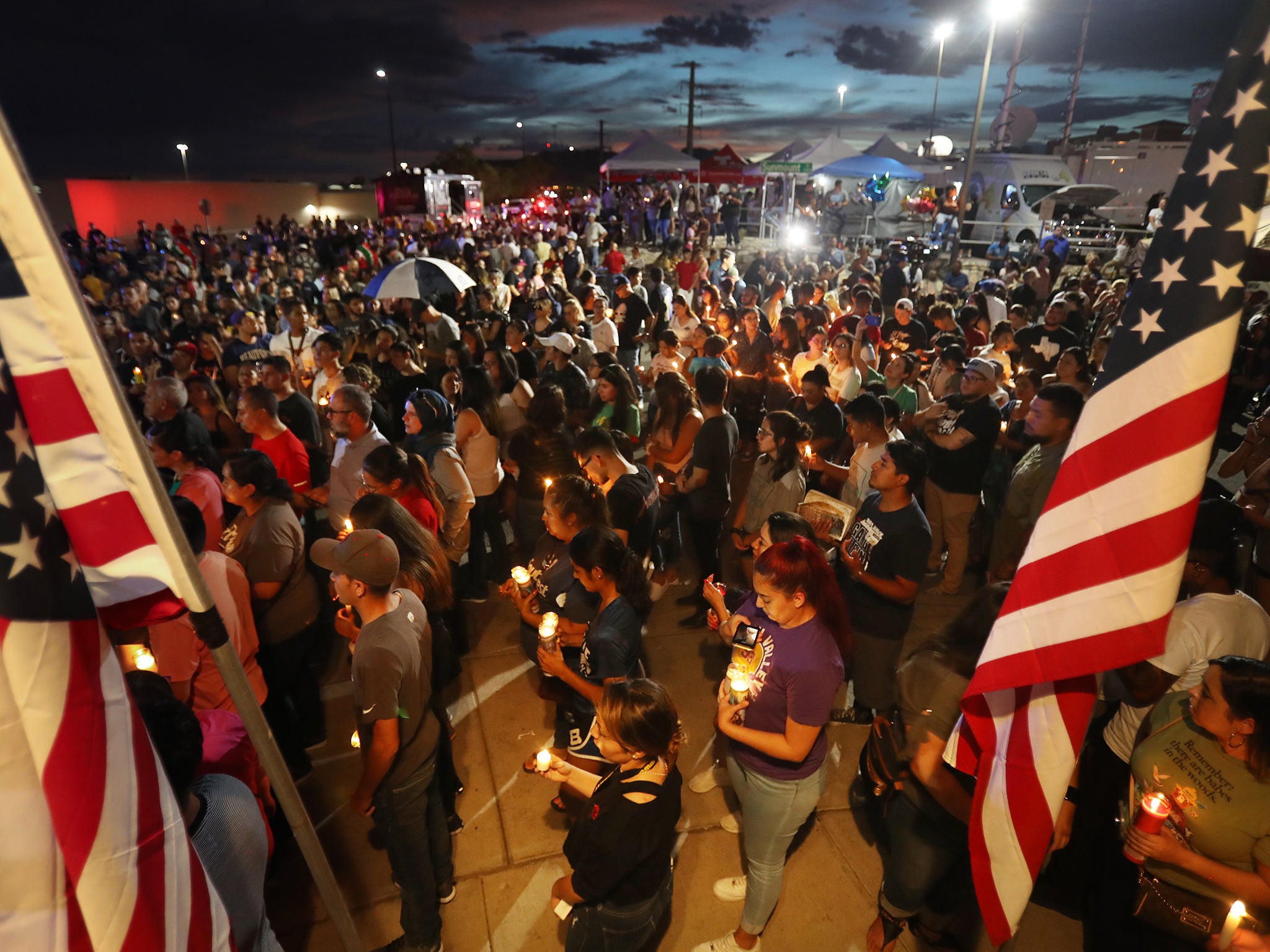 People attend a candlelight vigil at a makeshift memorial honouring victims of El Paso