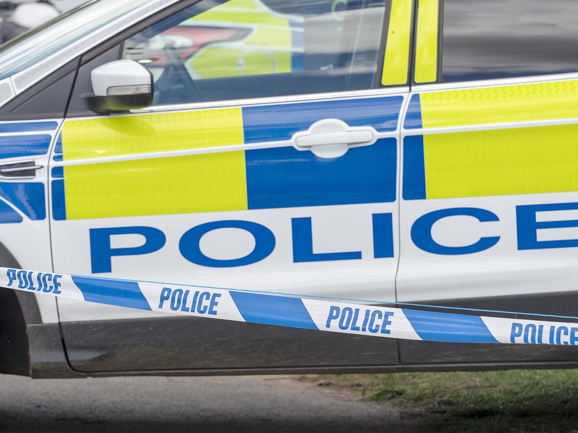 Police car and tape cordon