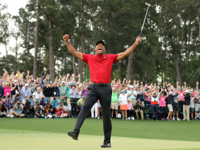 Tiger Woods celebrates clinching his fifth Green Jacket