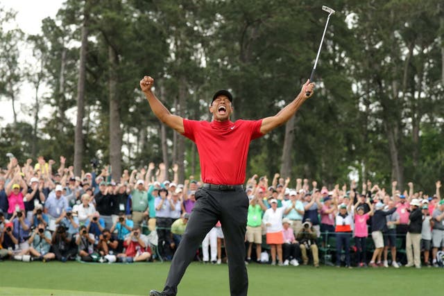 Tiger Woods celebrates clinching his fifth Green Jacket
