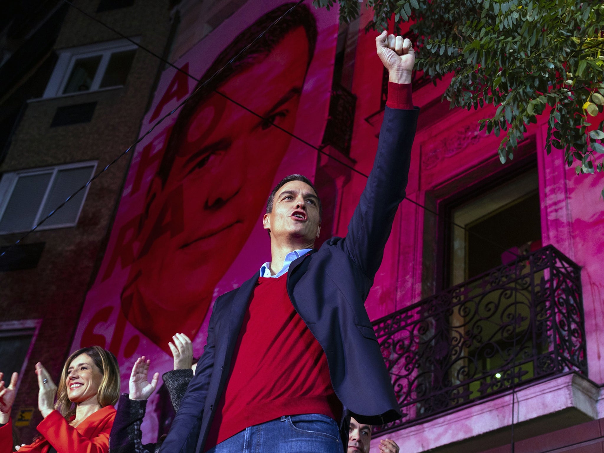 Pedro Sanchez waves to supporters while celebrating at the Socialist party headquarters in Madrid
