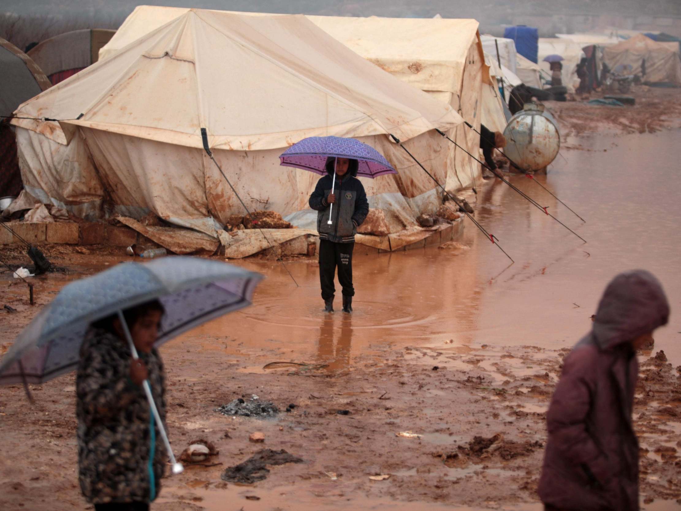 Syrian children in a camp for displaced people in Kafr Dariyan, a short distance from Syria’s border with Turkey, on 28 December 2019 (AFP via Getty)