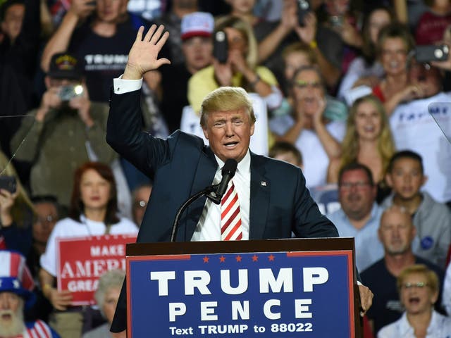 Trump waves during a campaign rally in Prescott Valley, Arizona