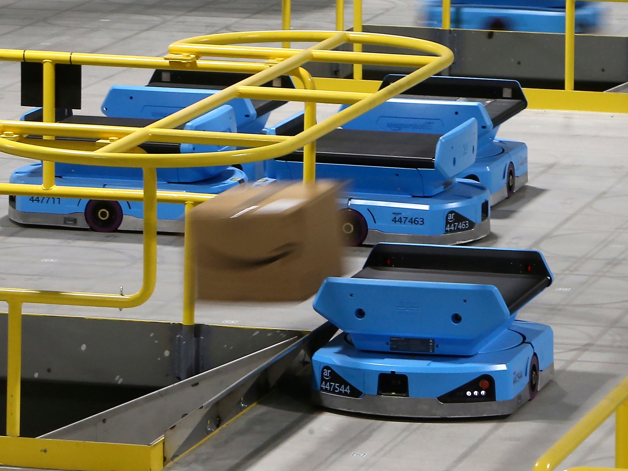 Robots sends packages down a chute which will deliver them to workers