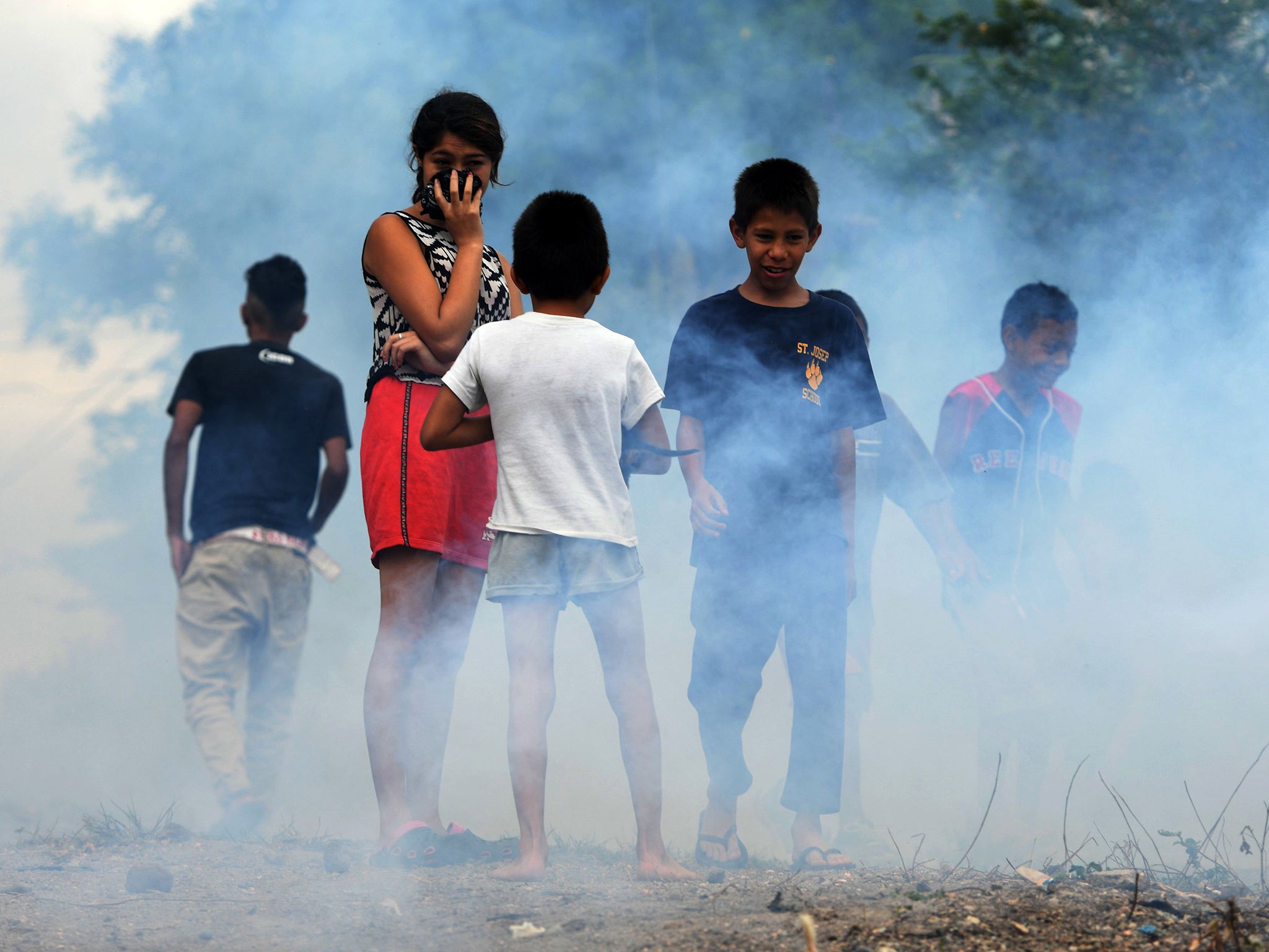 Children play in the streets as officials attempt to rid areas of the virus