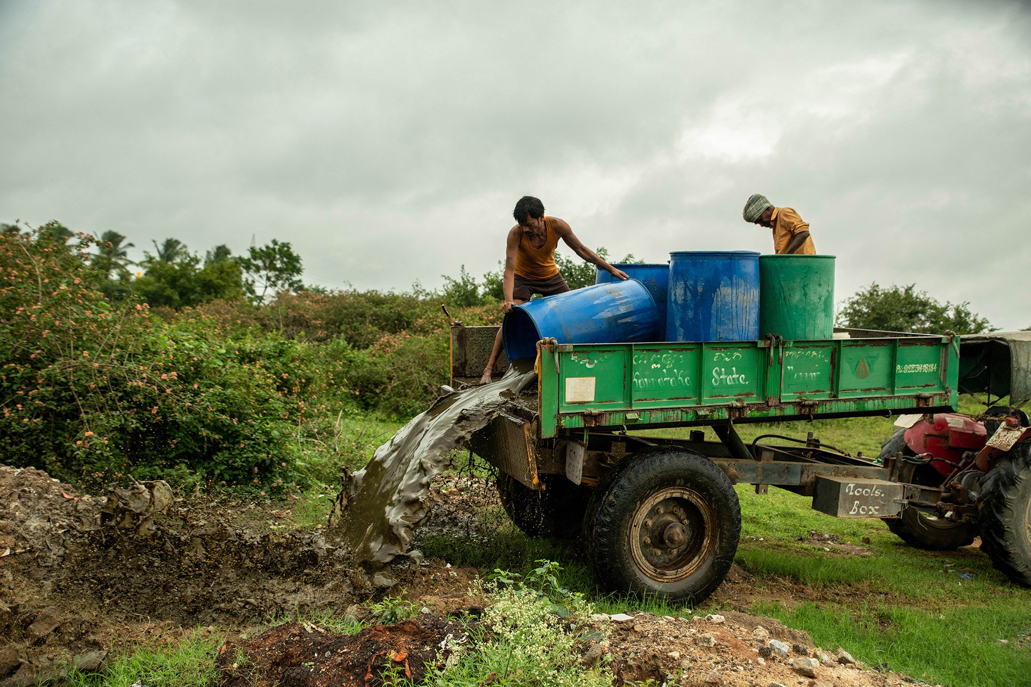 After emptying the pits, workers dispose of the sewage in a nearly field