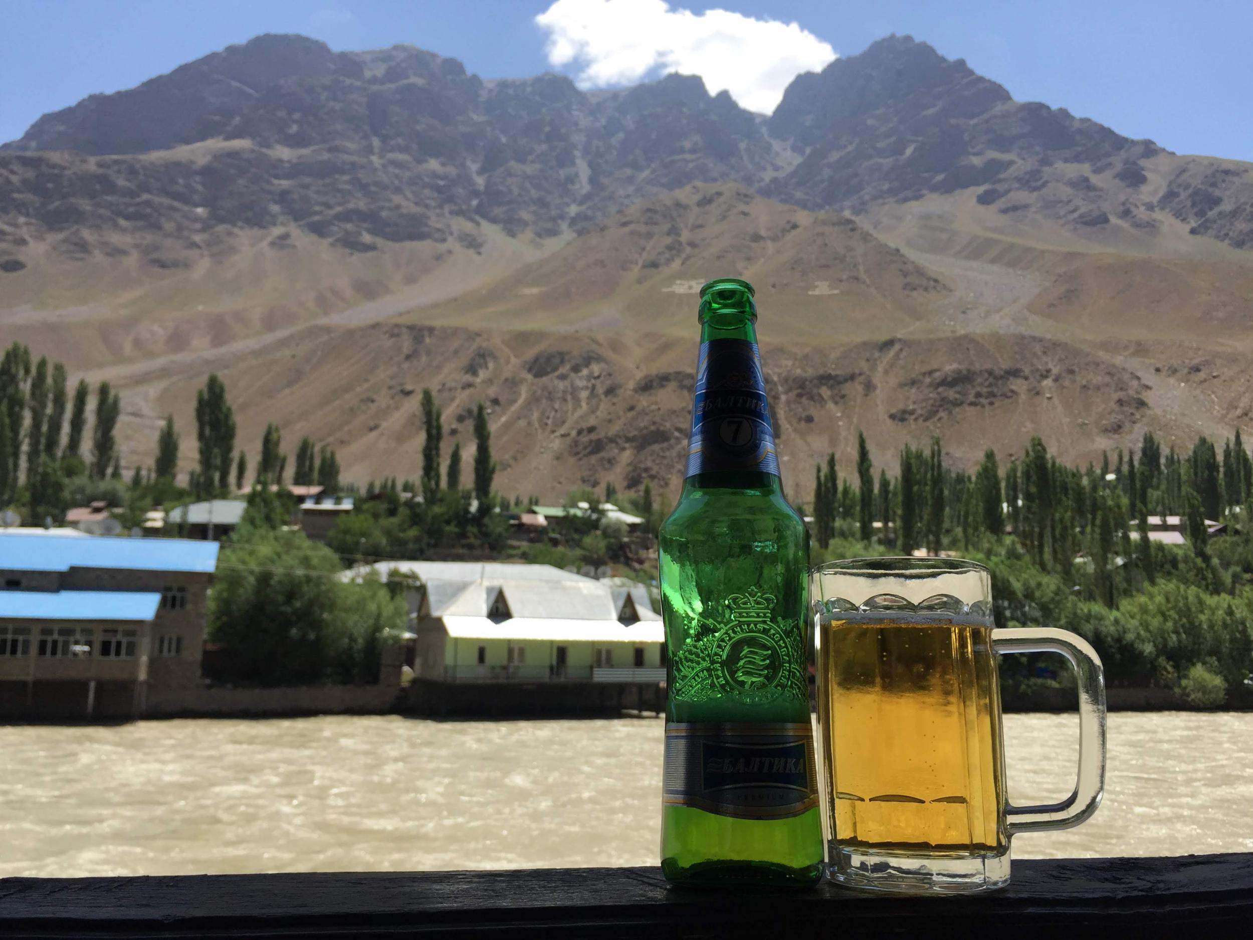 Drinking beer by the Panj River in Khorog