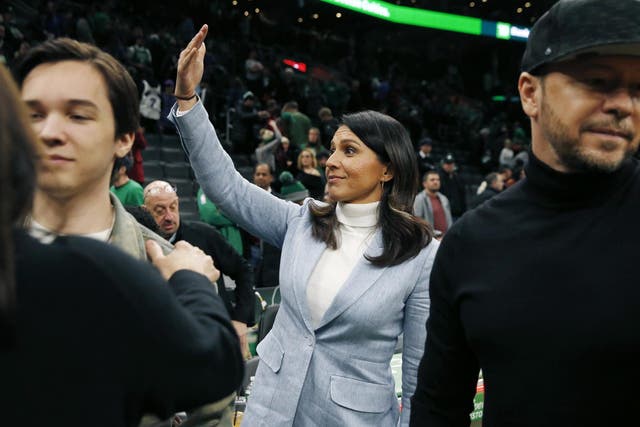 Presidential candidate, U.S. Rep. Tulsi Gabbard, D-Hawaii, center, gestures following an NBA basketball game between the Boston Celtics and the Toronto Raptors