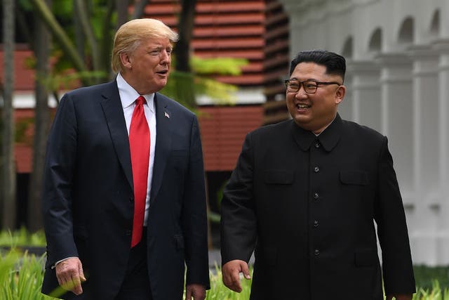 Trump and Kim take a stroll during a break in talks at the Capella in Singapore on 12 June 2018