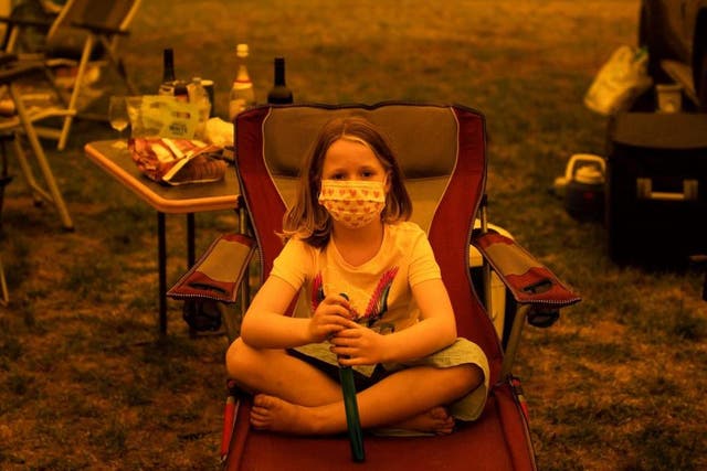 Amy Spencer sits at the showgrounds in the southern New South Wales town of Bega where evacuees are camping after escaping the bushfires