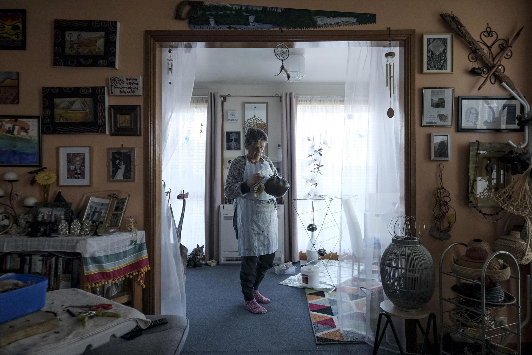 Aboriginal elder Nannette Shaw oils a kelp basket at her home in Launceston, Tasmania. Shaw makes baskets from kelp using traditional techniques