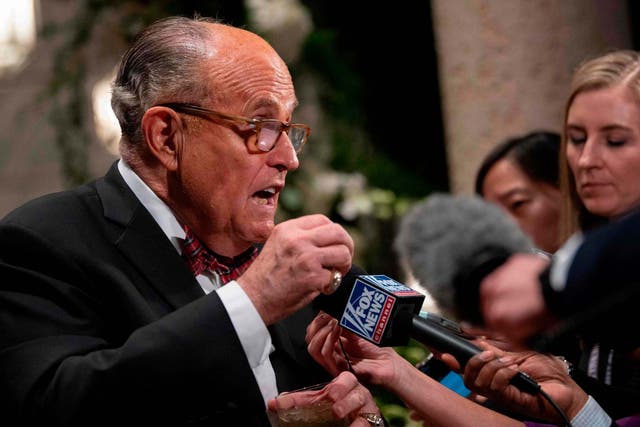 Donald Trump's personal lawyer Rudy Giuliani speaks at Mar-a-Lago outside the grand ballroom New Year celebration, in Palm Beach Florida on December 31 2019.