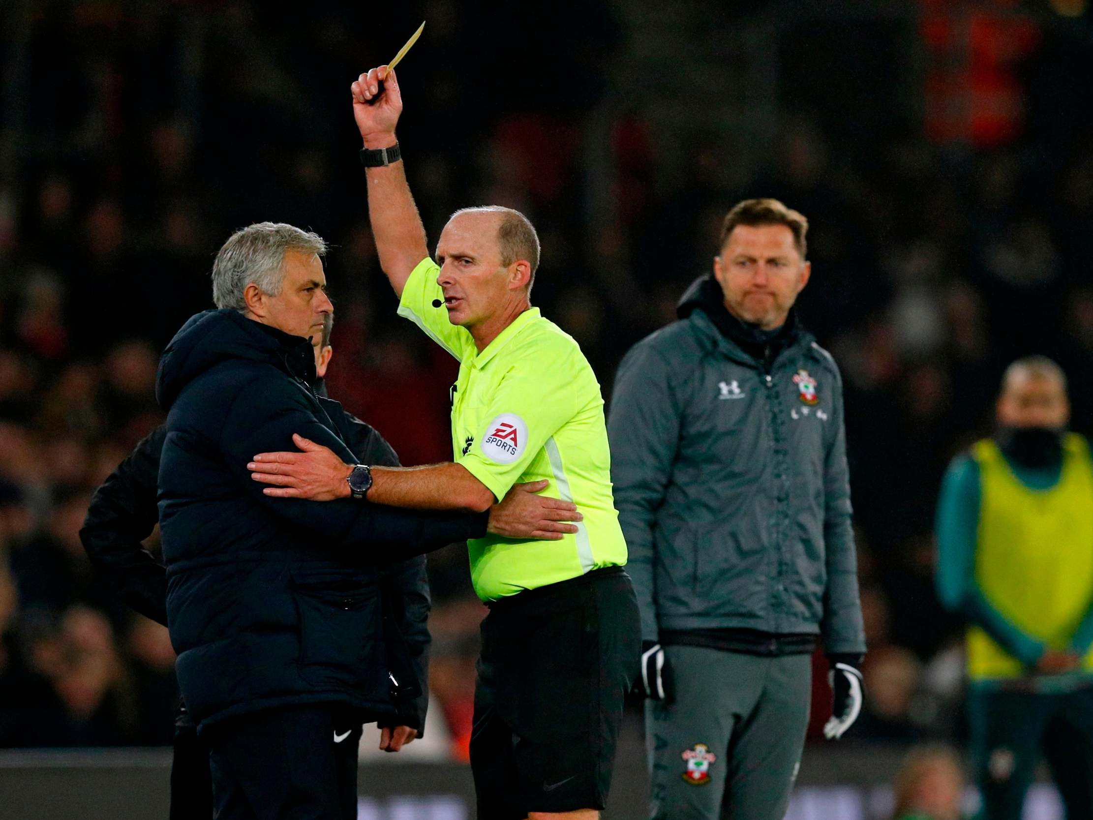 Jose Mourinho is booked by referee Mike Dean