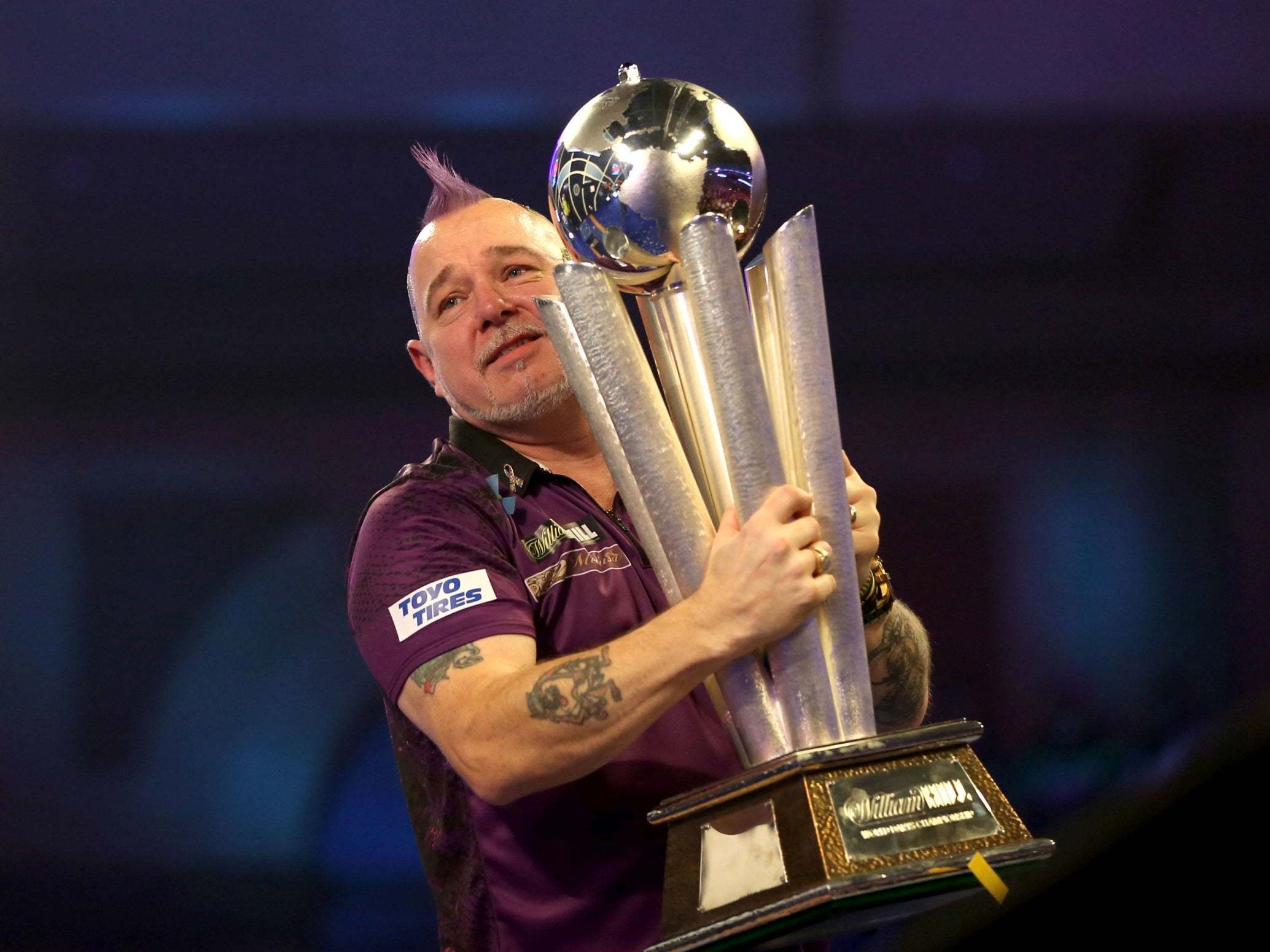 Peter Wright celebrates with the trophy at Alexandra Palace