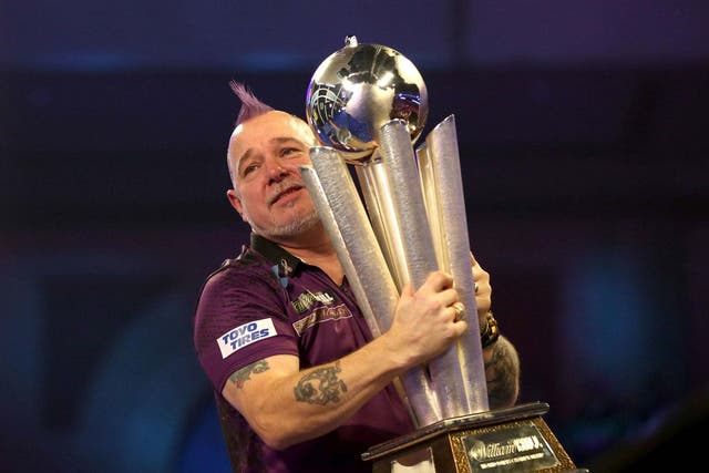 Peter Wright celebrates with the trophy at Alexandra Palace